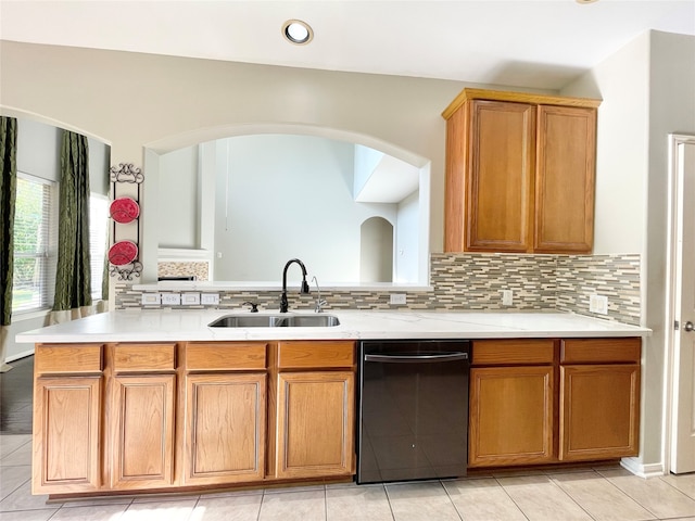 kitchen featuring backsplash, black dishwasher, light tile patterned flooring, and sink