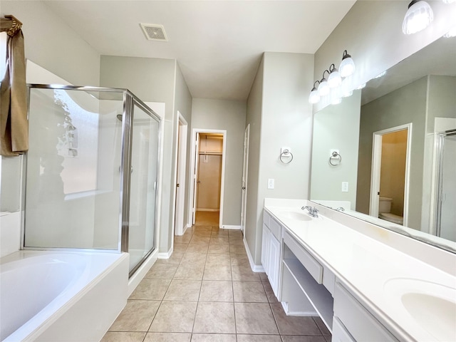 full bathroom featuring tile patterned flooring, vanity, and shower with separate bathtub