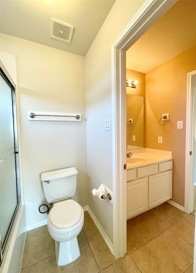 full bathroom featuring toilet, vanity, tile patterned floors, and shower / bath combination with glass door