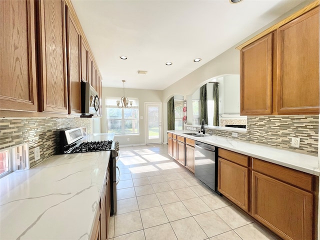 kitchen featuring hanging light fixtures, sink, appliances with stainless steel finishes, and tasteful backsplash