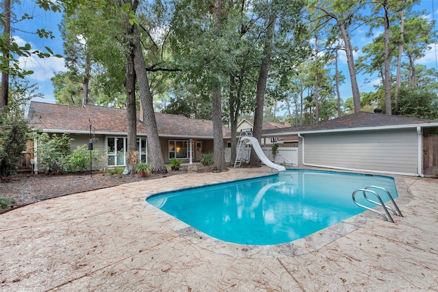 view of pool featuring a patio and a water slide