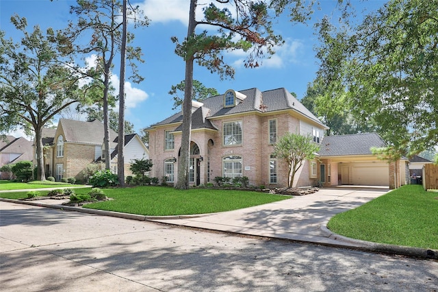 view of front of home with a front yard and a garage