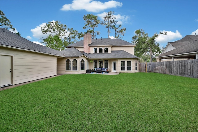 rear view of property featuring a lawn, a fenced backyard, a chimney, a patio area, and an outdoor living space