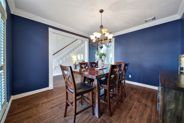 dining room featuring ornamental molding and an inviting chandelier