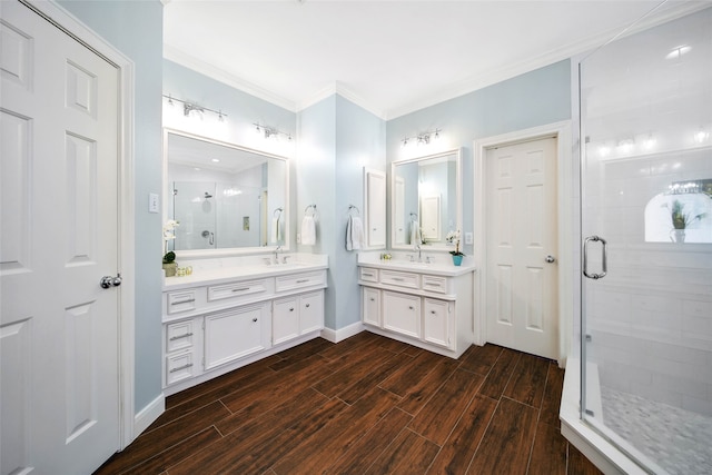 bathroom with vanity, an enclosed shower, and ornamental molding