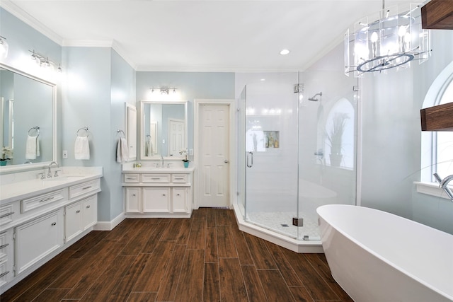 bathroom featuring plus walk in shower, vanity, and crown molding