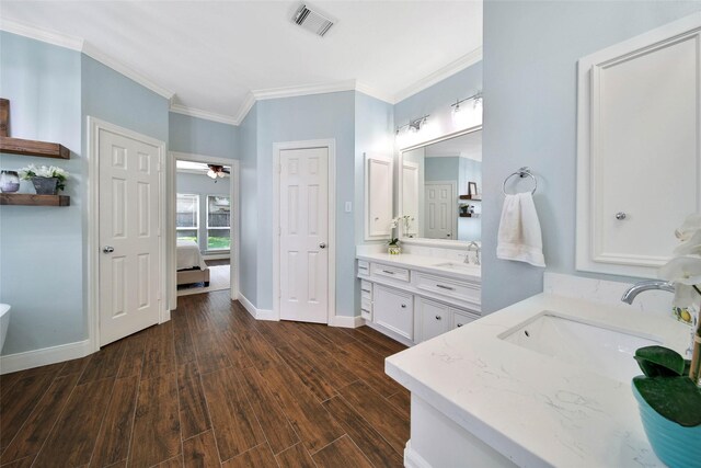 bathroom featuring ceiling fan, vanity, and ornamental molding