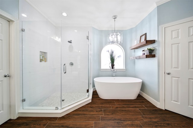 bathroom featuring independent shower and bath and a chandelier