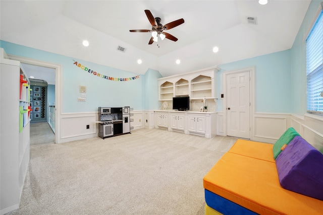 carpeted living room featuring ceiling fan and lofted ceiling