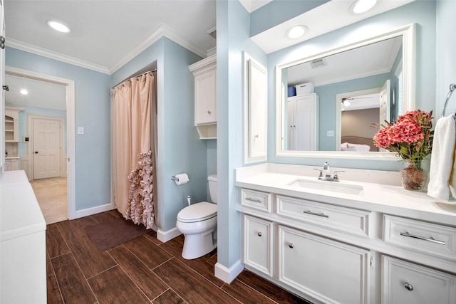 ensuite bathroom with connected bathroom, toilet, vanity, ornamental molding, and wood tiled floor