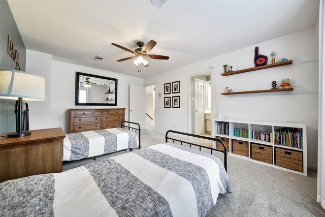 bedroom with carpet, ensuite bathroom, and ceiling fan