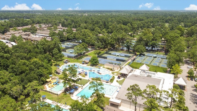 birds eye view of property featuring a view of trees