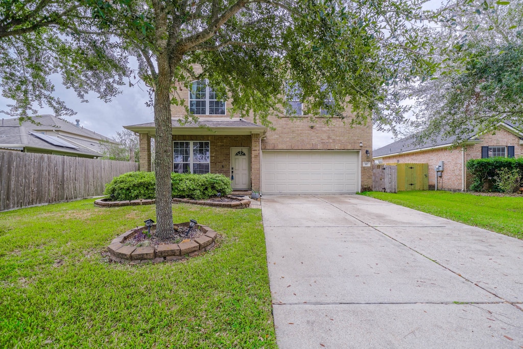 view of front of home with a garage and a front yard