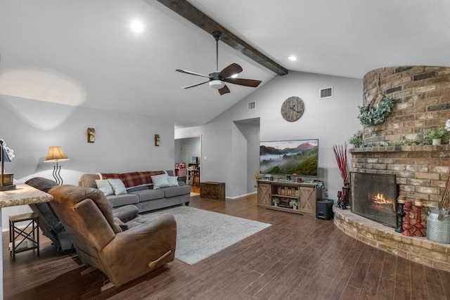 living area featuring beam ceiling, ceiling fan, dark wood finished floors, high vaulted ceiling, and a fireplace