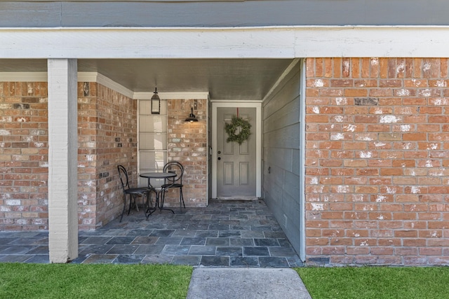 property entrance featuring brick siding