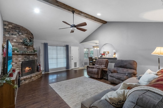 living room featuring beam ceiling, a ceiling fan, a fireplace, wood finished floors, and baseboards