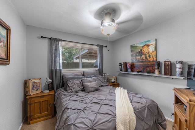 bedroom featuring carpet, a textured ceiling, and ceiling fan