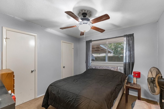 carpeted bedroom with a ceiling fan and baseboards