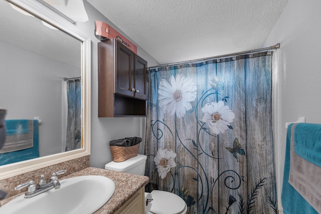 bathroom with vanity, a textured ceiling, toilet, and a shower with curtain