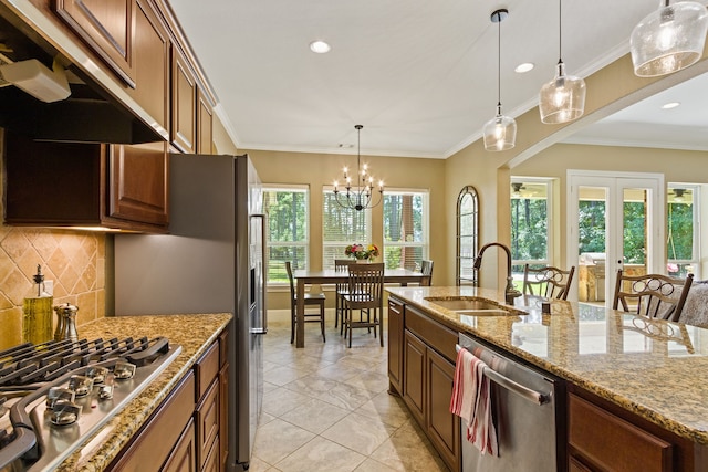 kitchen featuring light stone counters, sink, tasteful backsplash, ornamental molding, and appliances with stainless steel finishes