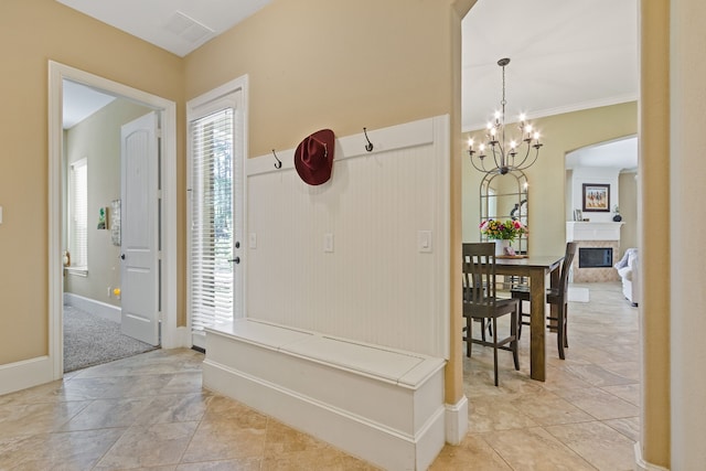 carpeted entrance foyer with ornamental molding