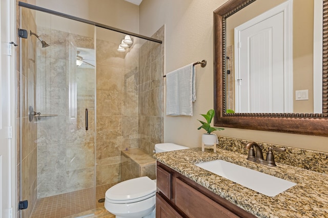 bathroom featuring walk in shower, ceiling fan, vanity, and toilet