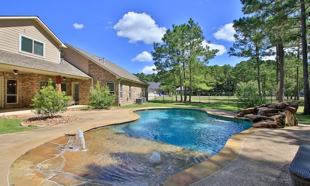 view of swimming pool with central AC and a patio