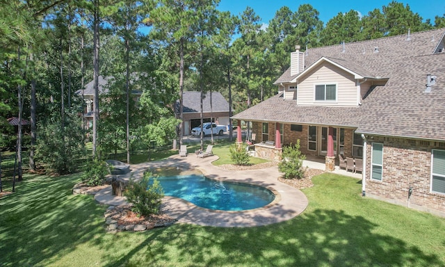 view of pool with a lawn and a patio