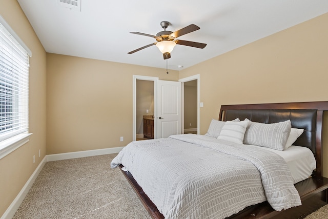 bedroom featuring ceiling fan, multiple windows, and carpet