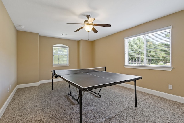 recreation room with carpet flooring and ceiling fan