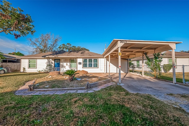 view of front of home with a front yard and a carport