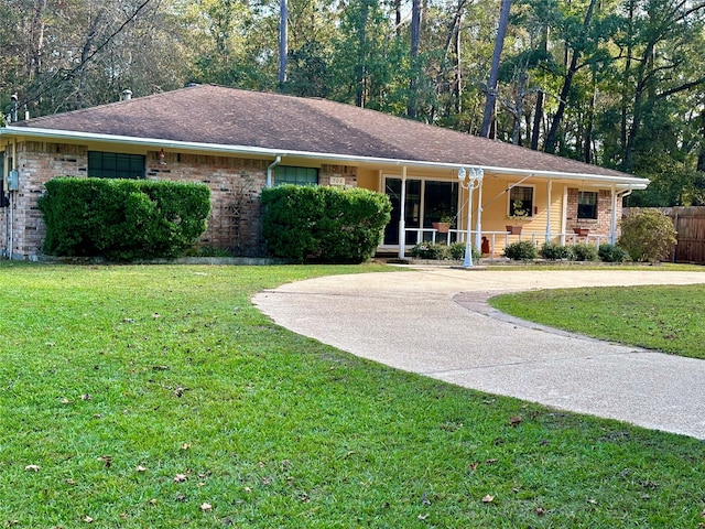 single story home featuring a front lawn and covered porch