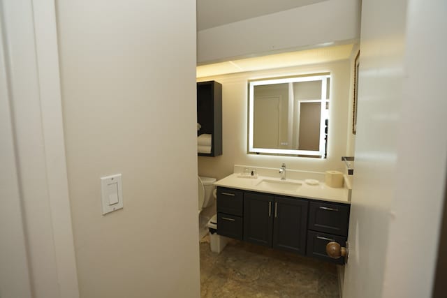 bathroom with toilet and vanity