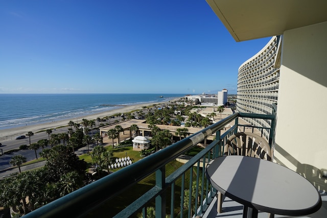 balcony featuring a view of the beach and a water view