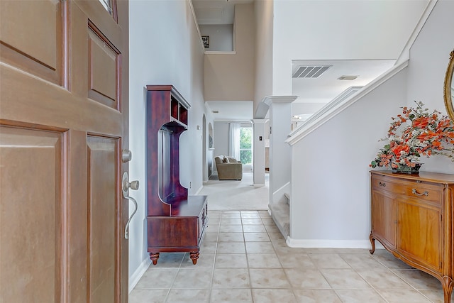 tiled entrance foyer with a high ceiling