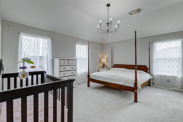 carpeted bedroom with a chandelier and multiple windows