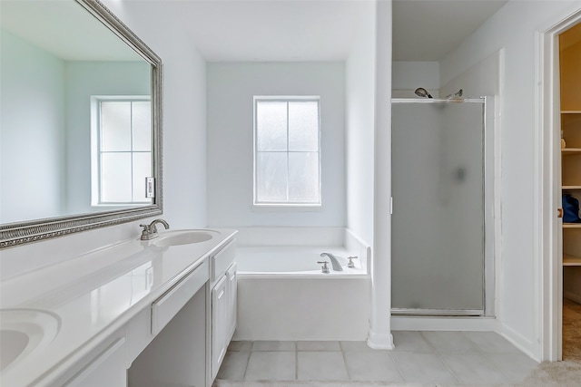 bathroom featuring independent shower and bath, vanity, and tile patterned floors