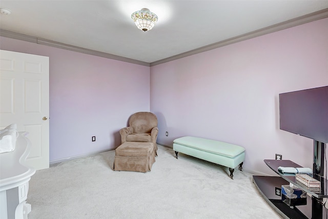 sitting room featuring carpet flooring and crown molding