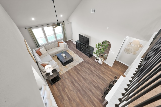 living room featuring high vaulted ceiling and hardwood / wood-style floors