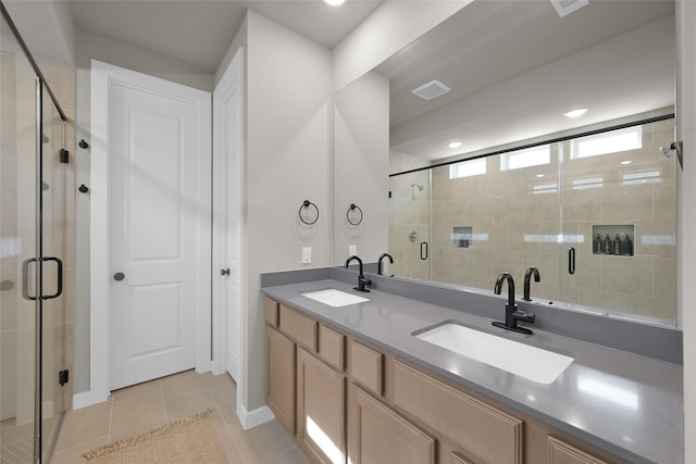 bathroom with tile patterned flooring, an enclosed shower, and vanity