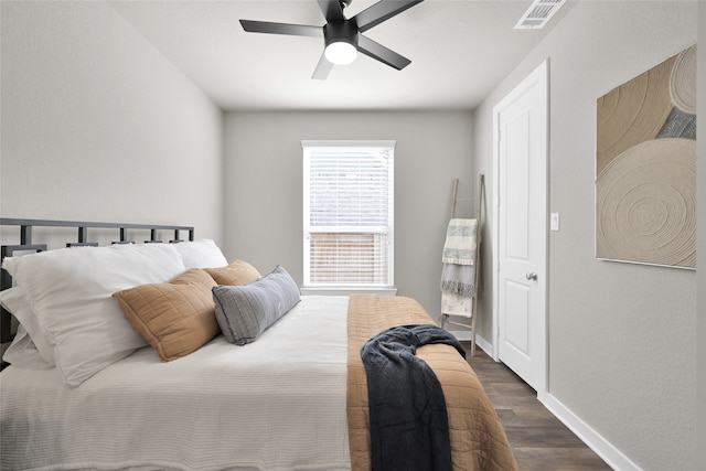 bedroom with ceiling fan and dark hardwood / wood-style floors