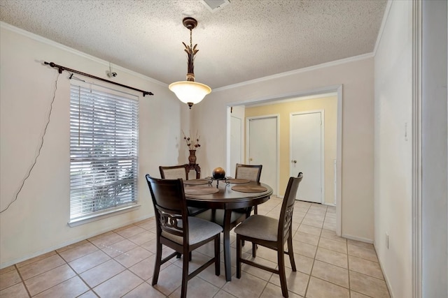 dining area with a textured ceiling, light tile patterned floors, and crown molding