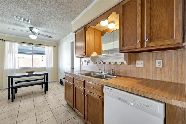 kitchen featuring ceiling fan, sink, white dishwasher, light tile patterned flooring, and ornamental molding