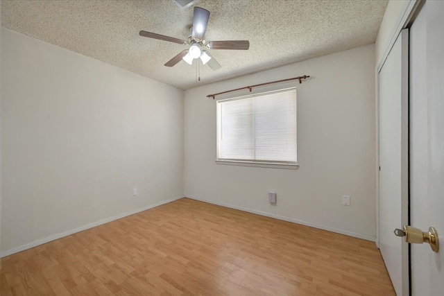 unfurnished bedroom featuring ceiling fan, a closet, a textured ceiling, and light wood-type flooring