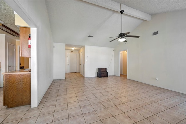 unfurnished living room featuring a textured ceiling, high vaulted ceiling, ceiling fan, and light tile patterned flooring