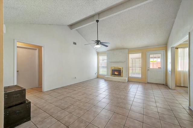 unfurnished living room featuring plenty of natural light, light tile patterned flooring, and a textured ceiling