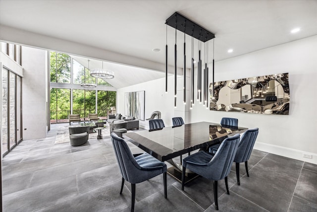 dining space with vaulted ceiling and a notable chandelier