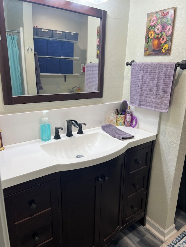 bathroom featuring hardwood / wood-style floors and vanity