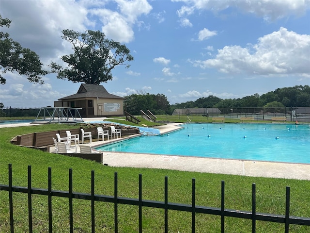 view of pool featuring a yard and a patio area