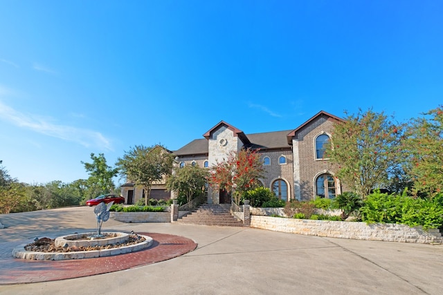 4 Steven Luke Ln, Friendswood, TX 77546 - view of front facade with curved driveway, brick siding, and stairs